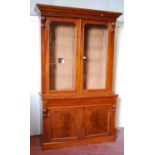 Victorian mahogany bookcase cabinet, the projected cornice over glazed doors enclosing shelves,