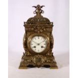 French gilded brass lantern clock with cherub finial decorated with mask, rose, acanthus and other