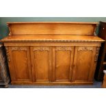 Victorian rosewood dresser with ledge back raised on whorl supports, the rectangular top with