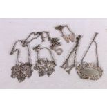 Seven silver decanter labels including four in the form of initials W, H, S and M, two Victorian