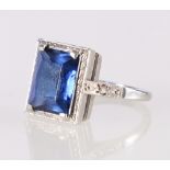 Palladium Art Deco style dress ring set with central blue faceted baguette stone, makers marks AWC&