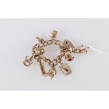 9ct gold curb link charm bracelet with heart shaped padlock closure and nine dependant charms