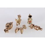 Five 9ct gold hallmarked charms including Clown Bust, Toby Jug, Dog, Wolf and a Poodle, 21.4g gross