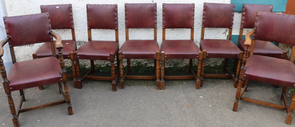 Set of eight oak panel back dining chairs including two carvers raised on turned supports