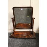 Victorian mahogany swing dressing glass raised on scroll supports and breakfront plinth base