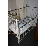 Victorian painted steel and brass cot bed raised on castors, 130cm long