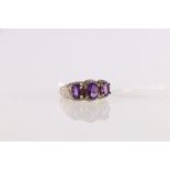 Scottish style possibly 15ct white gold dress ring set with three faceted amethysts having scroll