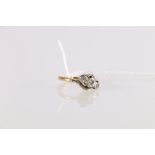 18ct gold and platinum three-stone diamond ring in a crossover setting, stamped 18ct and Plat,