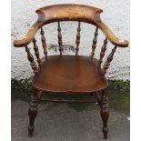 Antique smoker's bow chair with typical yoke back, turned spindle back raised on turned supports