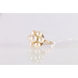 18ct gold pearl dress ring, the seven pearls set in flowerhead form, the central pearl approximately