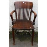 19th century oak desk chair with spar back, scroll arms, saddled seat and raised on cabriole