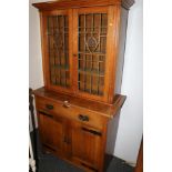 Art Nouveau oak cabinet bookcase with leaded stained glass doors, single frieze drawer over two