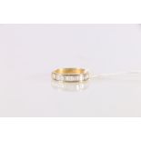 Unhallmarked 18ct gold eternity ring set with half hoop of baguette diamonds, ring size R, 3.85g