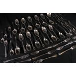 George V silver part suite of flatware comprising two ladles, eleven dessert spoons, eleven table