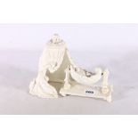 Grainger Worcester bisque porcelain group of a baby in cradle under canopy, stamped Graingers