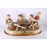 Capodimonte porcelain figure group of four young boys playing cards titled "The Card Cheat", 50cm