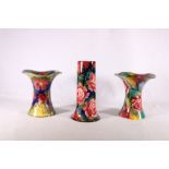 Three Wemyss Ware vases, one of inverted trumpet form decorated with roses, painted pattern number