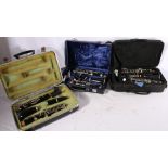 Three clarinets in fitted cases including Romilly Sonata, Hanson Ebonite of England and Buffet