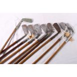 Nine hickory shafted golf clubs including: Schneider, stainless putter; J. Andrew, Bridge of Weir,