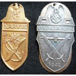 A German WW II Narvik Shield in brass. No prongs. Also a Demjansk Shield in good condition, no cloth