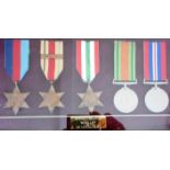 Framed set of WW II medals. 1939-45, Africa with 1st Army clasp, Italy Stars. Defence and War