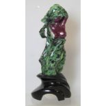 Eastern green zoisite and ruby corundum carved figure of a nude female torso on black slate plinth