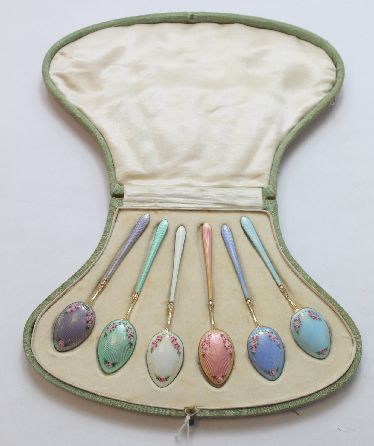 Set of six silver gilt coffee spoons with floral polychrome enamel, 1913, cased.