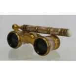 Pair of French mother-of-pearl and gilt metal opera glasses with folding handle by Iris, Paris, in a