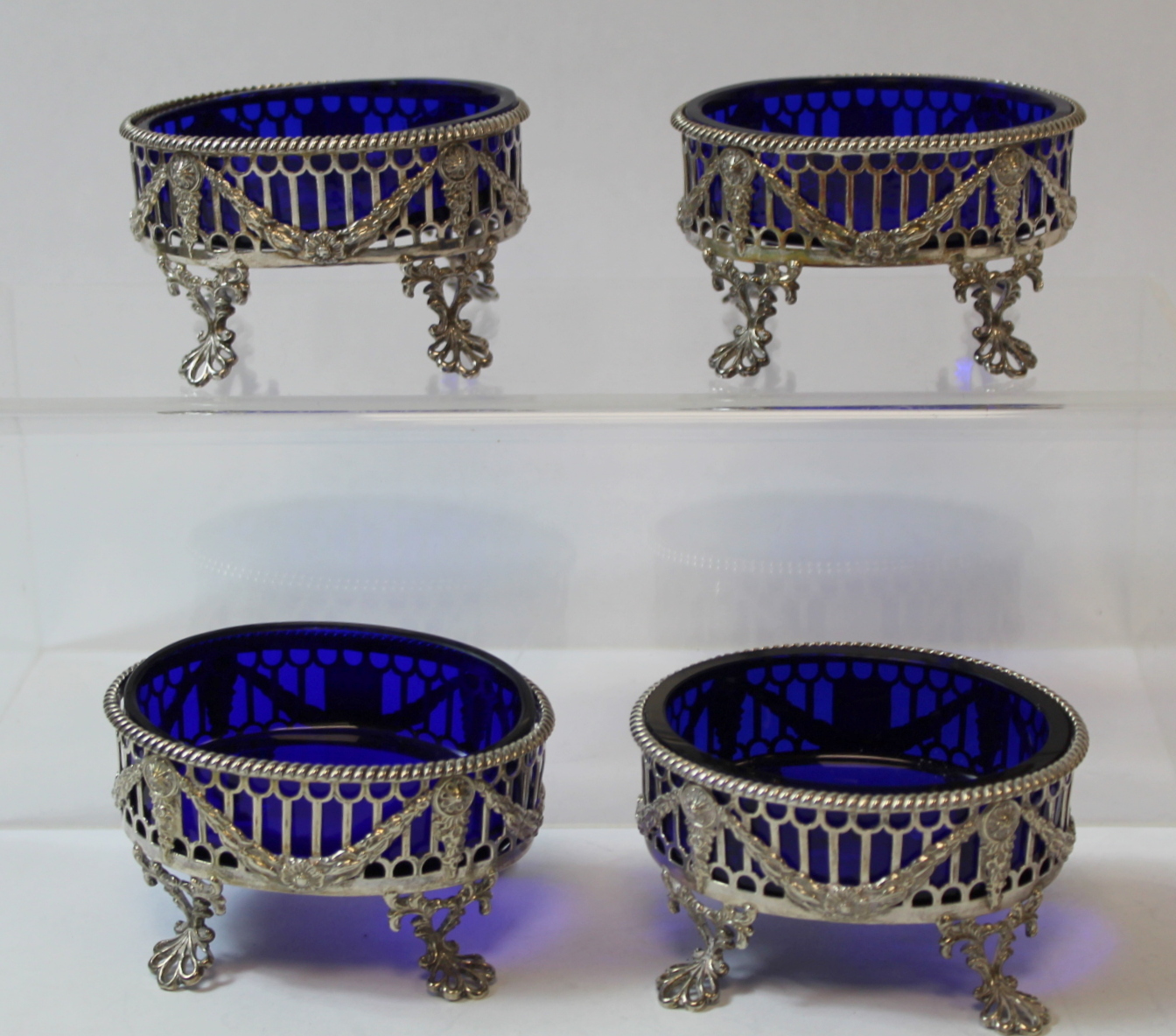 Set of four silver oval salts, pierced with applied embossed swags upon openwork spreading feet, - Image 7 of 8