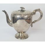 Silver tea pot of half ovoid shape, part engraved with scrolls, on spreading moulded foot by I. J.