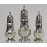 Set of three Queen Anne silver casters of octagonal baluster shape in two sizes, engraved with