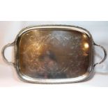 Silver tray of bowed rectangular shape with engraved scrolls, gadrooned border and handles,