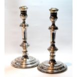 Pair of silver table candlesticks of plain baluster form, loaded, 25cm.