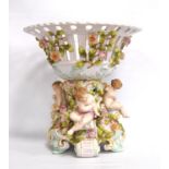 Meissen style centrepiece, the pierced basket decorated with roses, on foliate pedestal with