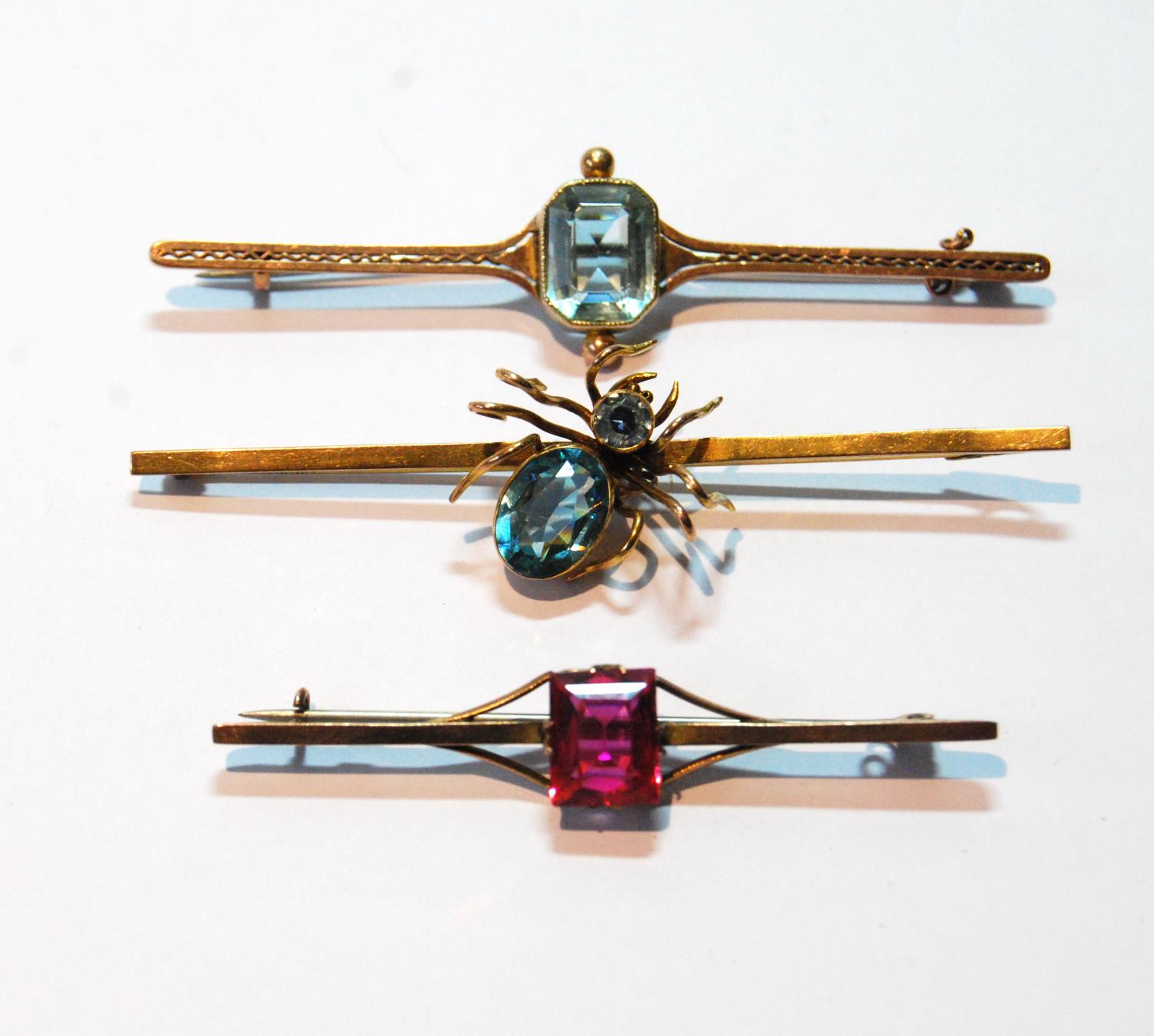 9ct gold brooch with blue spinel-set spider, Chester 1921, and two others.