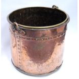 Copper pail with riveted banding and brass handle, 38cm wide and 31cm high.