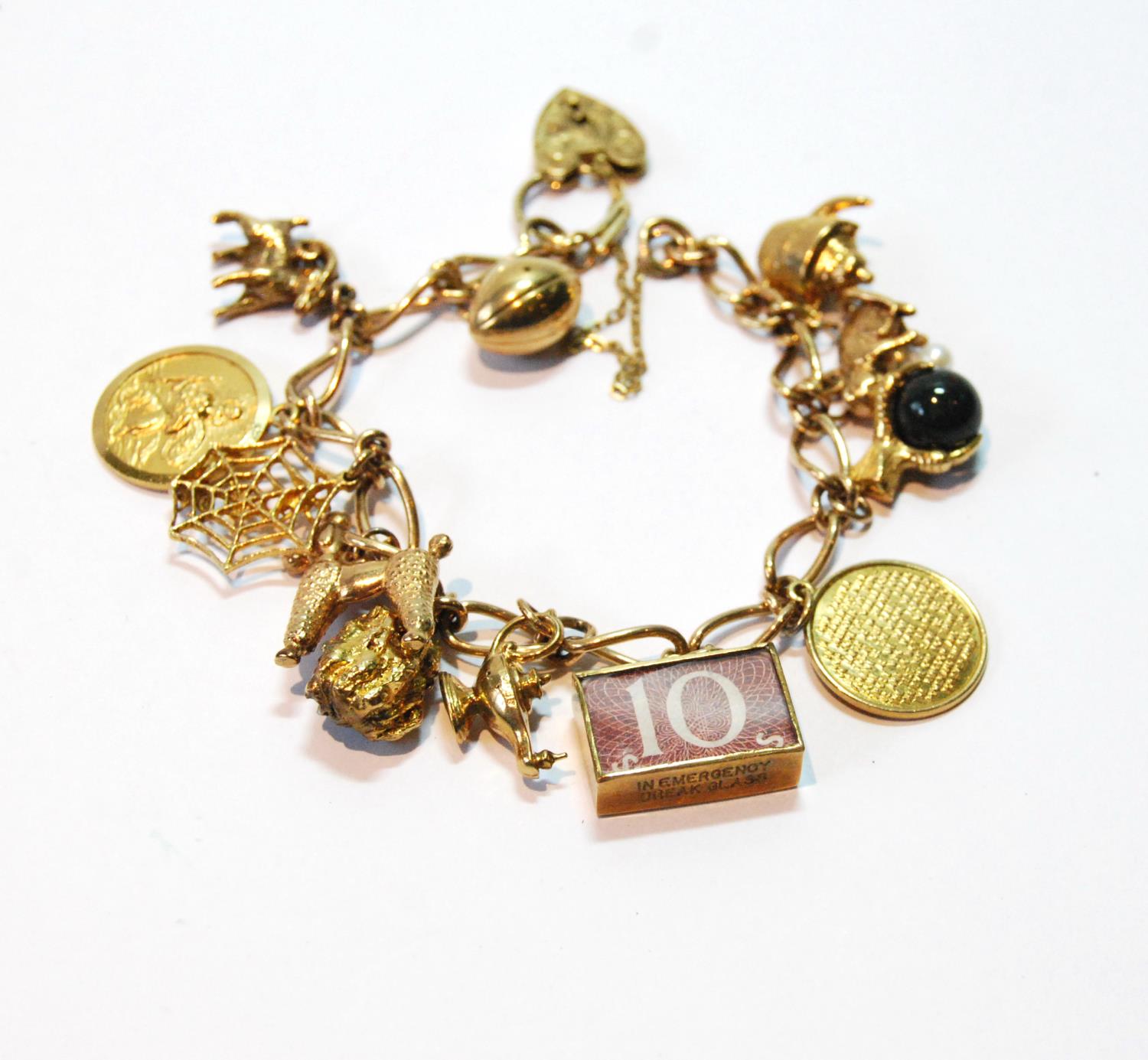 9ct gold open curb bracelet with various charms dependant, 39.8g gross.