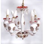 Five-branch cranberry and white glass electrolier with central baluster column, scrolling arms