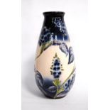 Florian ware vase with blue floral decoration, signed to the base, 32cm high.
