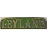 Cast-alloy BUS RADIATOR BADGE 'Leyland'. Background colour suggests it may be ex-Southdown Motor