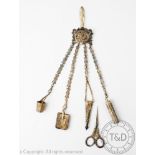 An Edwardian white metal chatelaine, hung with four drops, the top cast with an English Rose,