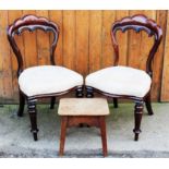 A pair of early Victorian mahogany dining chairs, with shell shaped backs, on turned legs,