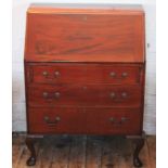 A 1920's mahogany bureau, with fall enclosing a fitted interior, above three graduated long drawers,