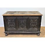 A George III and later oak chest, with later carved panelled top and front, on turned legs,