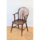 A 19th century ash and elm wheel back Windsor chair, with solid seat on turned legs,