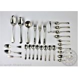 An assorted collection of silver flatware, to include; a set of five silver teaspoons,