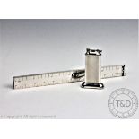 A Dunhill novelty silver plated table lighter modelled as a ruler, 32.