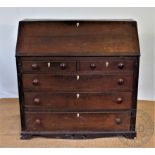 A late George III oak bureau, with fall enclosing a fitted interior,