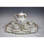 A French porcelain cabaret set in the manner of Limoges, comprising; four teacups and saucers,