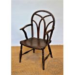 An early 19th century ash and elm country kitchen Windsor type chair, with solid seat,